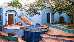una casa azul con piscina en el patio en Milkwood Beach Villa, en Wilderness