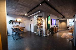 a room with a table and chairs and a wine cellar at Zarautz Surf House in Zarautz