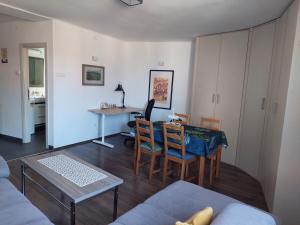 a living room with a table and chairs and a kitchen at Charming and stylish centrally located 50m2 in Belgrade +13 photos