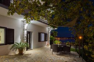 a patio of a house with a table and chairs at Apartments Panorama in Trogir