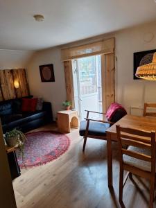 a living room with a couch and a table at Stuga ROS Naturcamping Lagom in Gräsmark