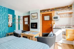a room with a bed and a table and a kitchen at Local Bruges hospitality, flavors and free parking 3 in Bruges