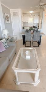 a living room with a couch and a table at Best Ocean View & Sunset - Los Cristianos in Los Cristianos +32 photos