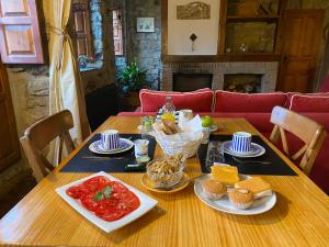 a wooden table with food on top of it at Casa Rural Basiver - Habitación Pico San Carlos in Armaño