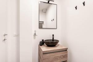 a bathroom with a sink and a mirror on a wooden vanity at Ca' San Marco - A Due Passi Dalla Basilica in Vicenza +11 photos