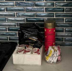 a table with a cup of coffee and some snacks at Luxury Designer Villa by the Beach Bright Beautiful Brand New in Galveston