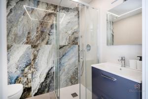 a bathroom with a shower and a toilet and a sink at Downtown Apartments Dolci Coccole The Terrace in Bari +34 photos