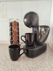 a coffee maker and two cups on a counter at Los Deseos De Vera in La Cala de Mijas +15 photos