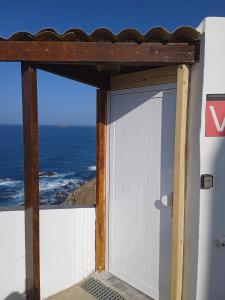 a white door with a view of the ocean at Casa lucas in Almáciga