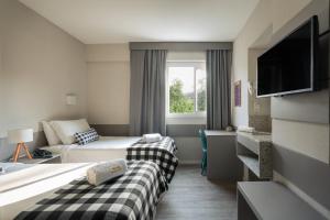 Postel nebo postele na pokoji v ubytování Work Hotel Design