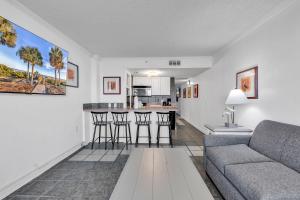 a living room with a couch and a kitchen at Meridian Plaza 404 in Myrtle Beach +21 photos