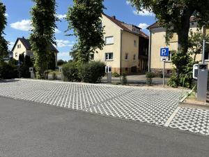 a cobblestone street with a parking lot in front of houses at Landhotel Georgshof in Hünfeld