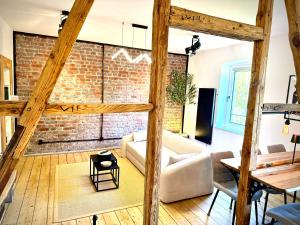 a living room with a brick wall at Suburban Loft in Bochum