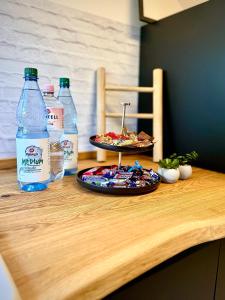 a table with a plate of food and bottles of water at Suburban Loft in Bochum