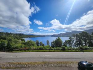 a view of a lake from the side of a road at Luichart Lodge in Lochluichart Station