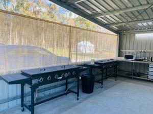 two ping pong tables in a building with a large window at Coonawarra Hampton Bubble 4 in Comaum