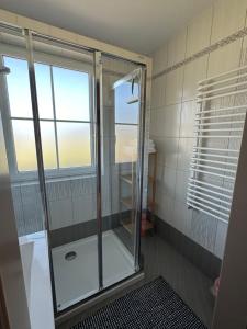 a shower with a glass door in a bathroom at Ferienhaus Santner in Tamsweg +55 photos