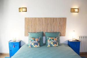 a bedroom with a blue bed with two blue night stands at Wanderlust - Beautiful Villa in Aljezur in Aljezur +25 photos