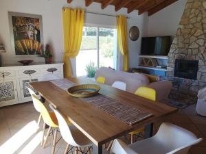 a living room with a wooden table and chairs at Wanderlust - Beautiful Villa in Aljezur in Aljezur