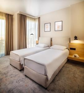 Postel nebo postele na pokoji v ubytování B1 Downtown Hotel