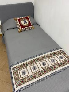 a bed with a pillow on top of it at Casa Marconi duplex avec terrasse in Aragona +57 photos