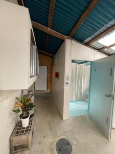 a room with a hallway with a blue ceiling at Stay&Explore Okuma,Yanbaru National Park,Cape Hedo in Kunigami