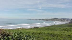 a view of a beach with boats in the water at Apartamentos Villa Sofía in San Vicente de la Barquera