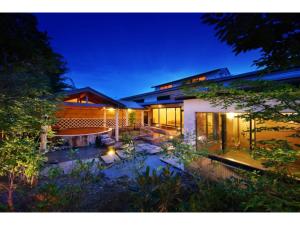 a house with a pond in the yard at night at OCEAN FRONT TATEYAMA - Vacation STAY 37303v in Tateyama