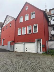 a large red building with white garage doors at Fiddelhof in Bad Hersfeld