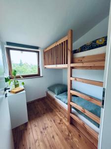 a bedroom with two bunk beds and a window at ökologisch Wohnen im Grünen in Marburg an der Lahn