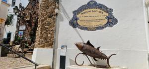 a sign with a fish sitting next to a building at Casa Alzira By ALzira in Albufeira +59 photos
