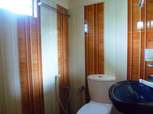 a bathroom with a toilet and a sink at The Nilmini Lodge in Sigiriya