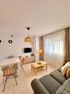 a living room with a couch and a table at Apartamentos J&K in Torremolinos +84 photos