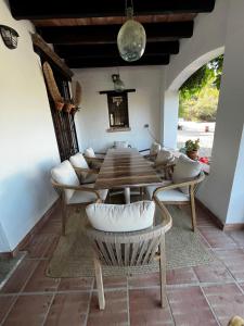 a dining room with a wooden table and chairs at Villa Trompetilla Montes de malaga with Yoga studio and Spa in Málaga
