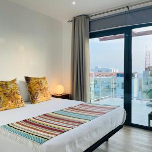 a bedroom with a bed and a large window at Sal Little Heart Grand Terrace Apartment 26 in Santa Maria