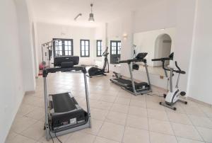 a gym with several treadmills and exercise bikes at Ambassador Aegean Luxury Hotel & Suites in Akrotiri