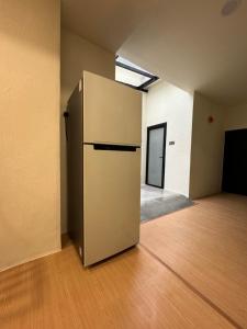 an empty room with a refrigerator in the middle of it at Allbes Klang Room in Klang