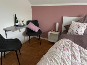 a bedroom with a bed and a table and chairs at Gästehaus Schorn in Zell an der Mosel