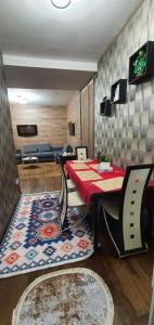 a room with a table and chairs and a couch at Apartament Anahita in Sinaia