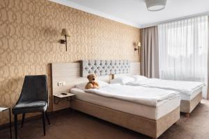 Postel nebo postele na pokoji v ubytování Hotel Podlasie
