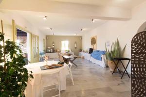 a living room with a table and a couch at Parosland Hotel in Aliki