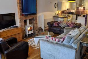 a living room with two couches and a fireplace at St Davids House in Cranbrook