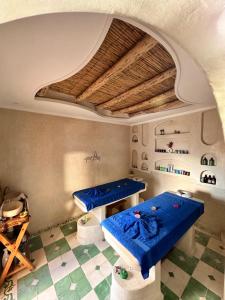 a room with two blue tables and a ceiling at Dar Salam Souss in Taroudant +21 photos