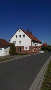 a large white building on the side of a street at Schenk´s Landgasthof in Amorbach
