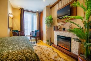 a bedroom with a fireplace and a tv above it at Lord Morgan & Exclusive Design Cihangir in Istanbul