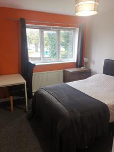 a bedroom with a bed and a window at Small double room Bromborough Wirral in Bromborough