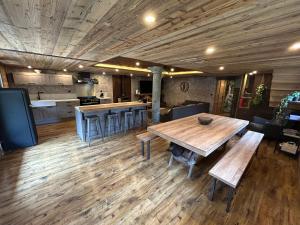 a large room with a large wooden table and chairs at Chalet d'alpage " L'Estive " in Saint-Sorlin-dʼArves +5 photos