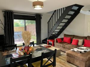 a living room with a couch and a table at Loft Le Petit Solognot in Mont-près-Chambord