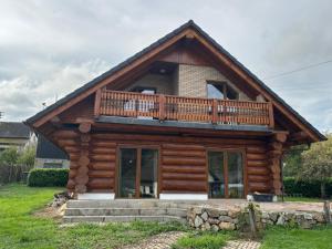 a log cabin with a balcony on top of it at Chalet Nicole in Piesport