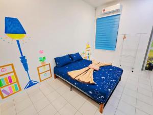 a room with a bed and a couch in it at GOLDEN HOUSE ,1min to aeon, 7min to zoo,8min to lake gardens in Taiping
